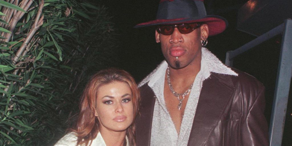 New Laker Dennis Rodman celebrates his first winning game out on the town at GOODBAR with wife Carmen Electra
